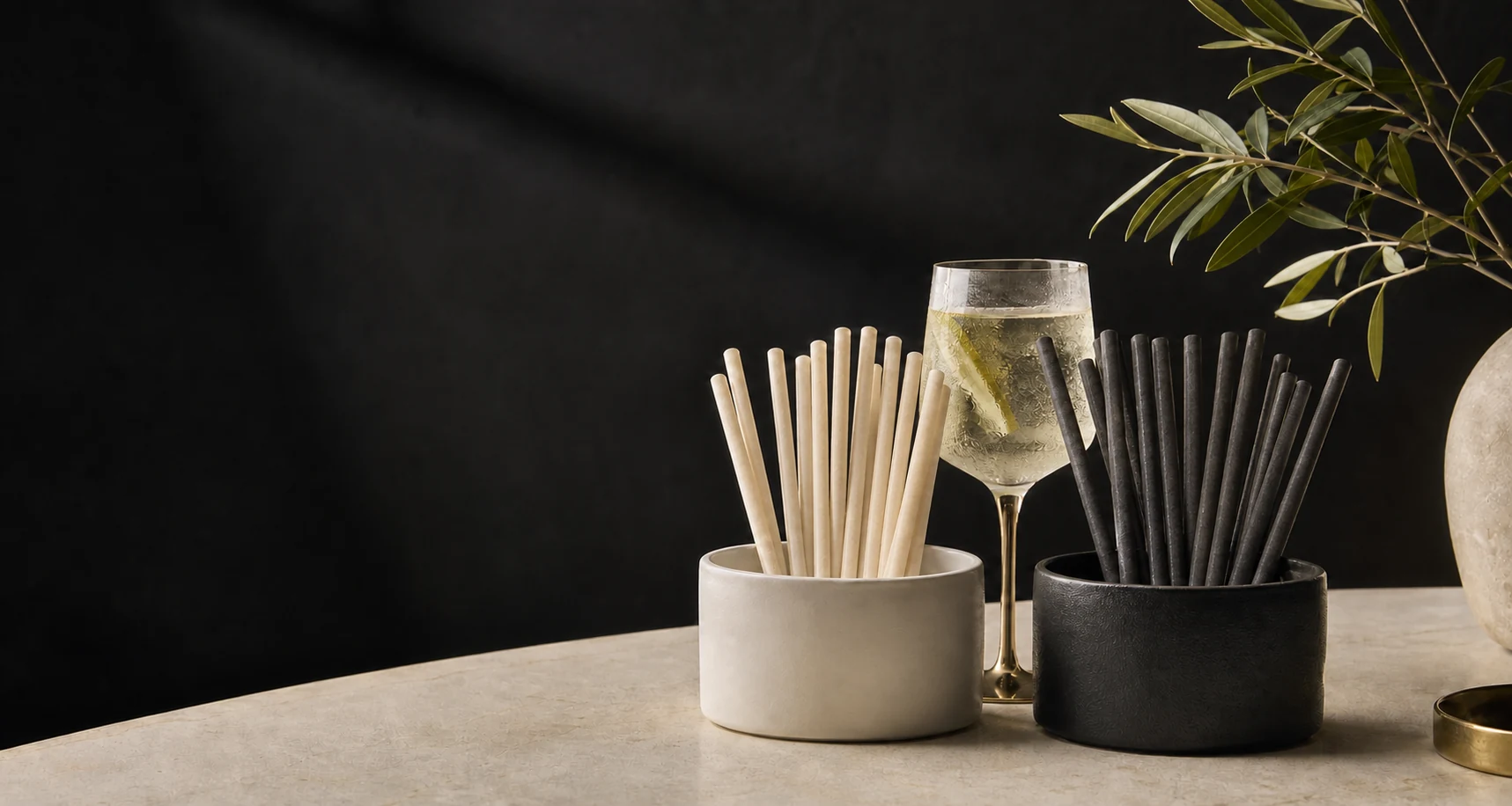 Natural ivory and graphite rice straws styled with an elegant cocktail glass